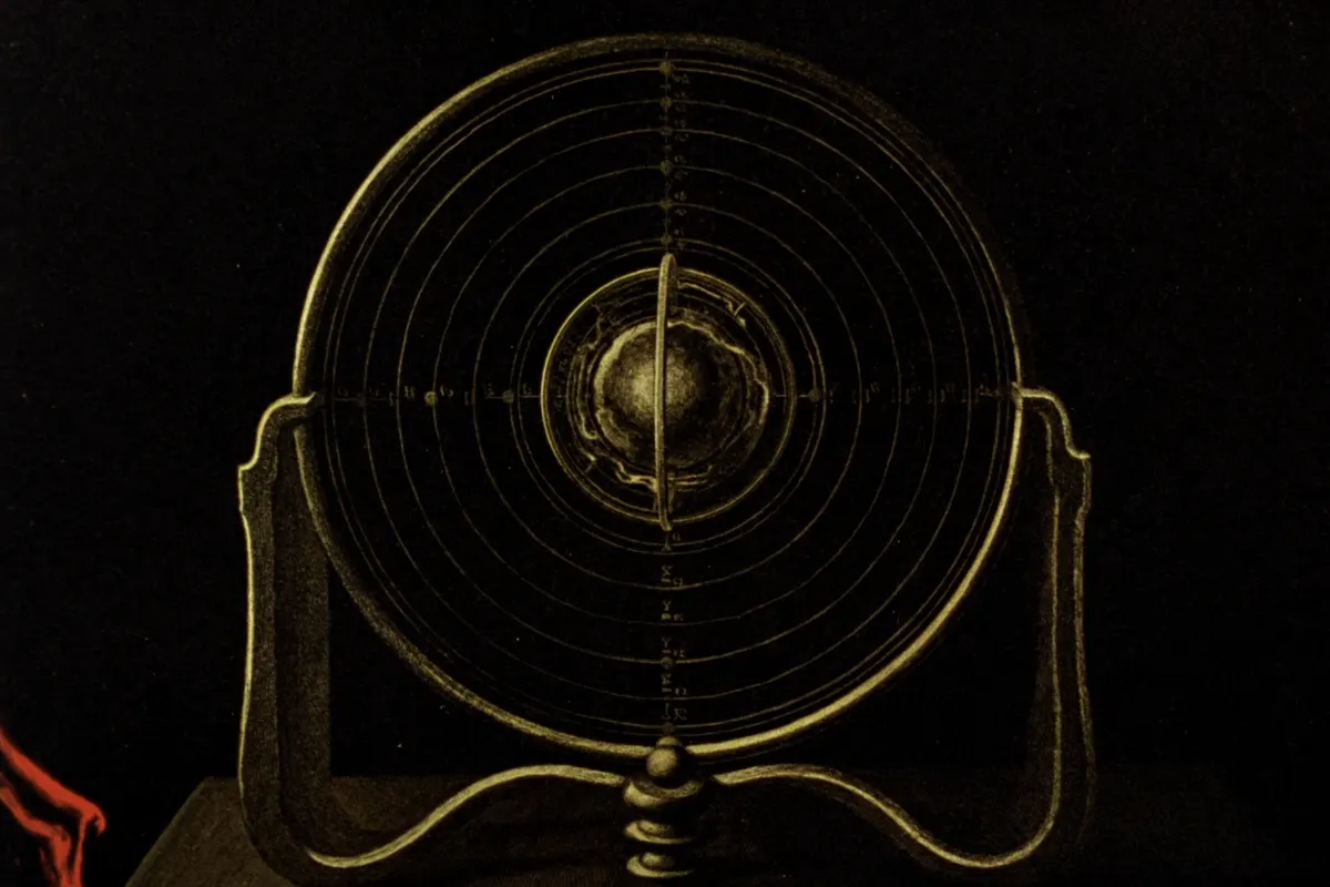 A brass armillary sphere, its nested rings around a small central Earth
